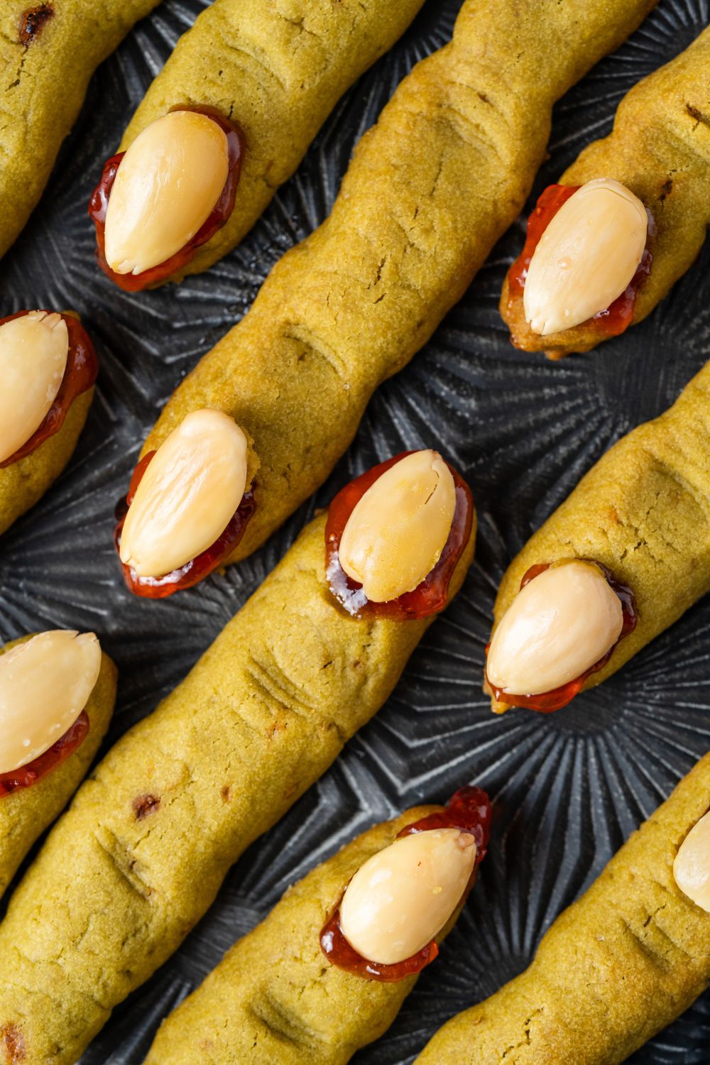 Witch Finger Cookies placed neatly on a black tray on table to see the detail of each cookie 