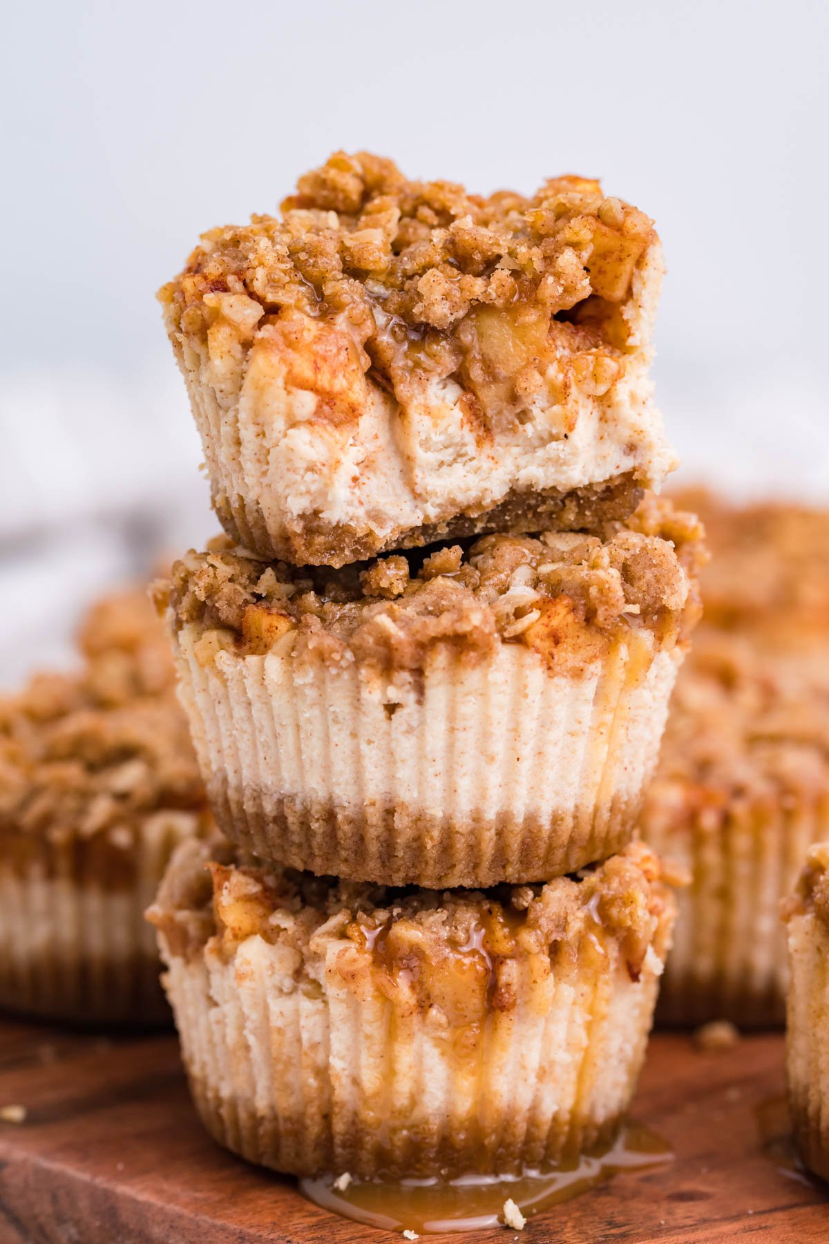 Stack of 3 Apple Crisp Cheesecakes with a bite missing from the top one