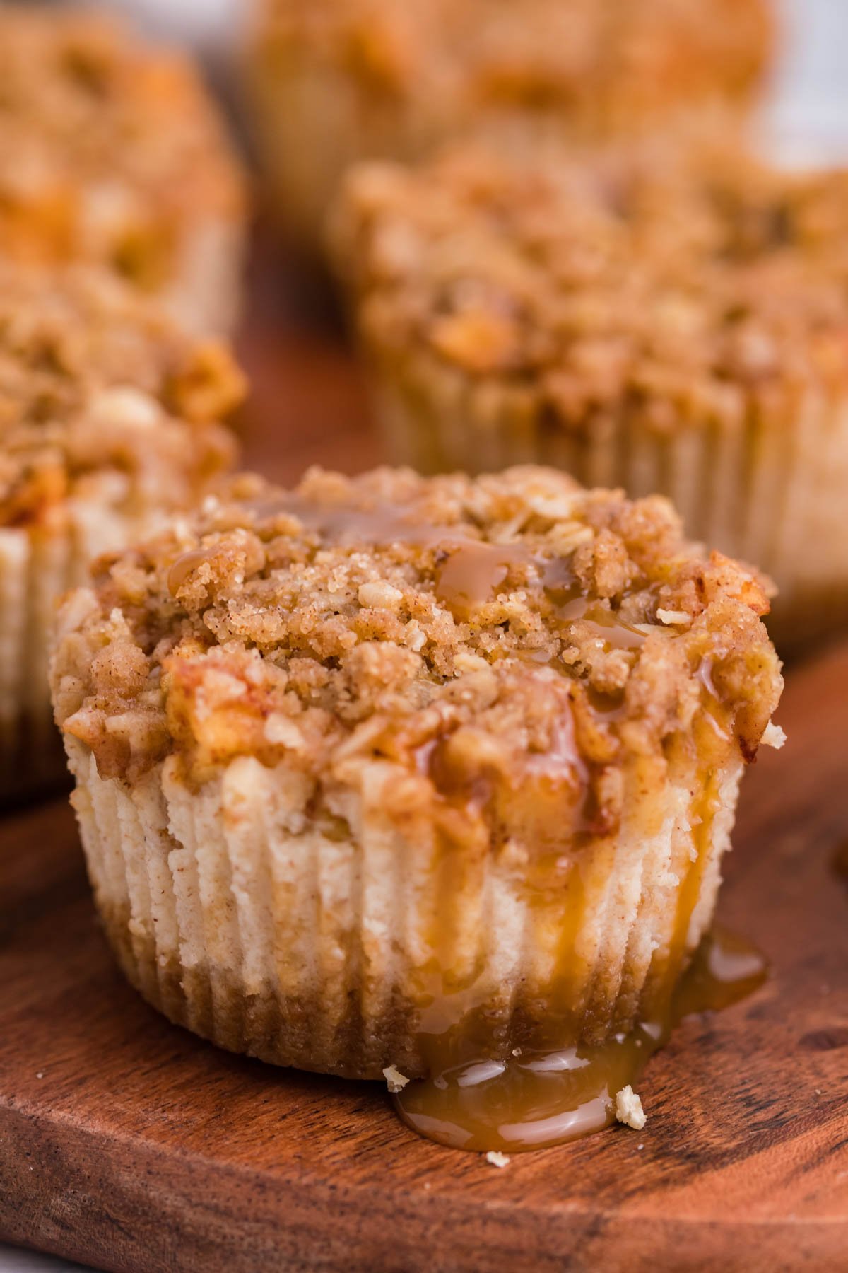 close up of the Apple Crisp Cheesecakes with drizzled caramel on top
