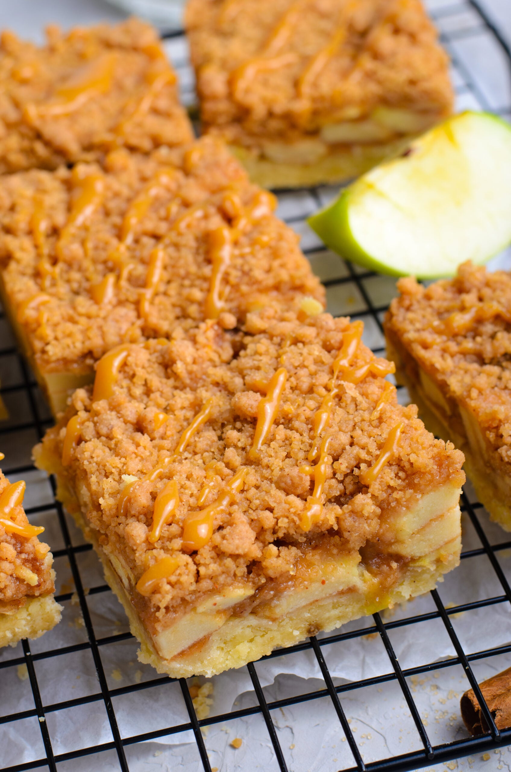 Up close angle of the Caramel Apple Pie Bars on a wire cooling rack