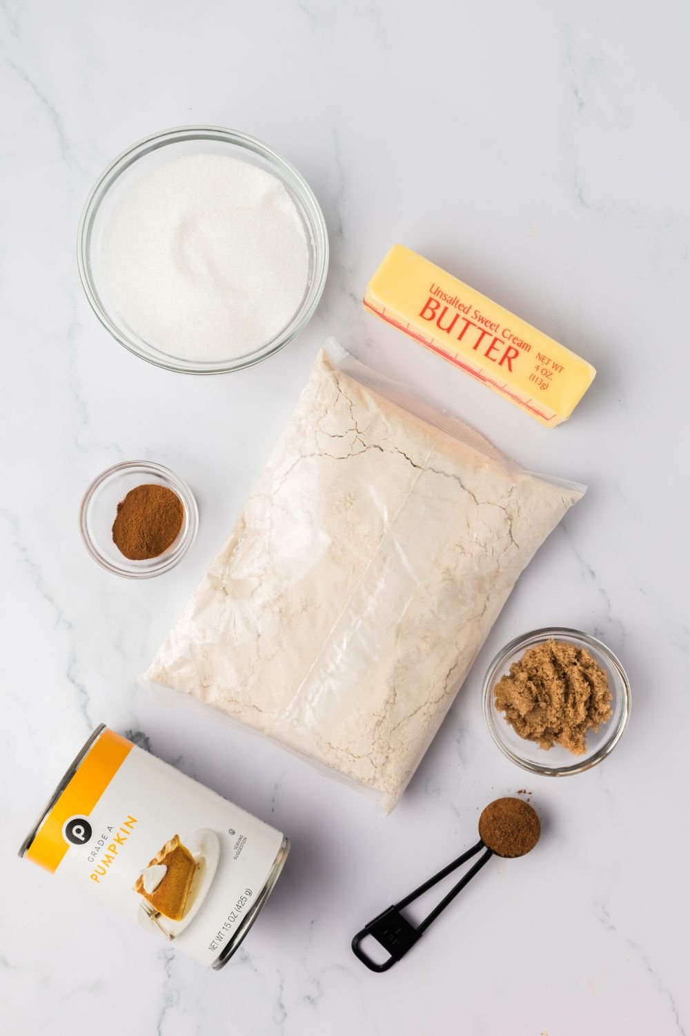 ingredients for making Baked pumpkin donut holes spread out on table in single serve containers 