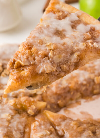 close up view of Easy Apple Pie Pizza slice being lifted up