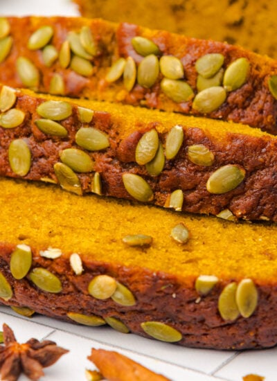Starbucks Pumpkin Bread sliced and placed on table with pumpkin seeds on top of each loaf