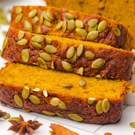 Starbucks Pumpkin Bread sliced and placed on table with pumpkin seeds on top of each loaf