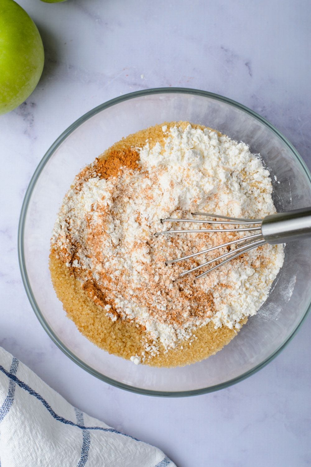 flour mixture with spices in a glass bowl with a whisk