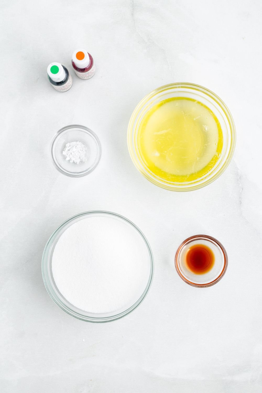 ingredients for making Pumpkin Meringues in glass dishes on a white counter 
