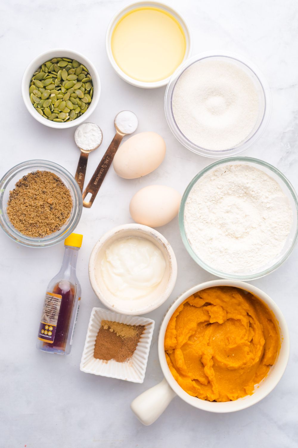 all the ingredients for Starbucks Pumpkin Bread in single serve containers on a white table 