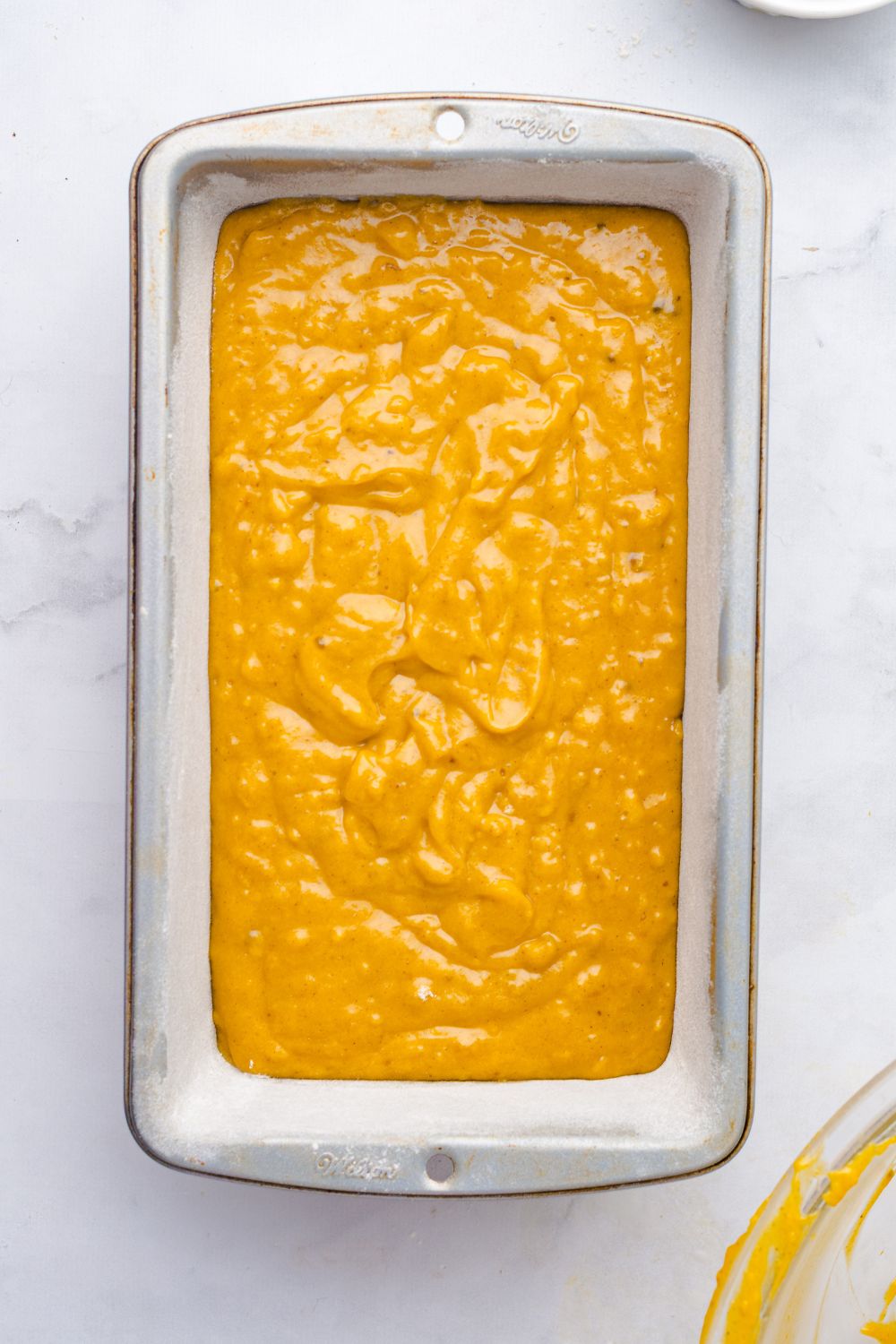 Starbucks Pumpkin Bread batter in a loaf pan on table 