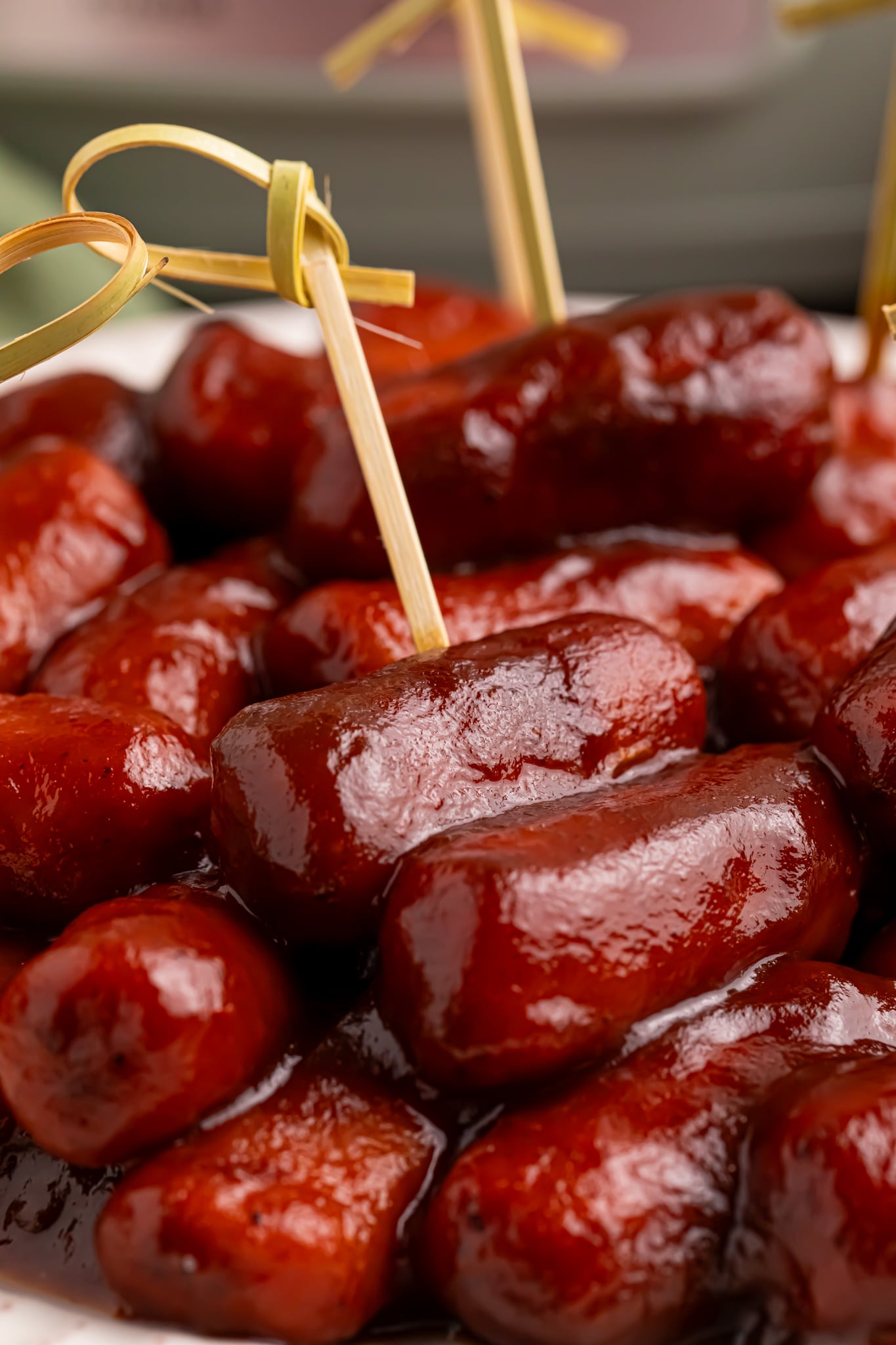 Apple Butter smokies on a white platter with toothpicks in them