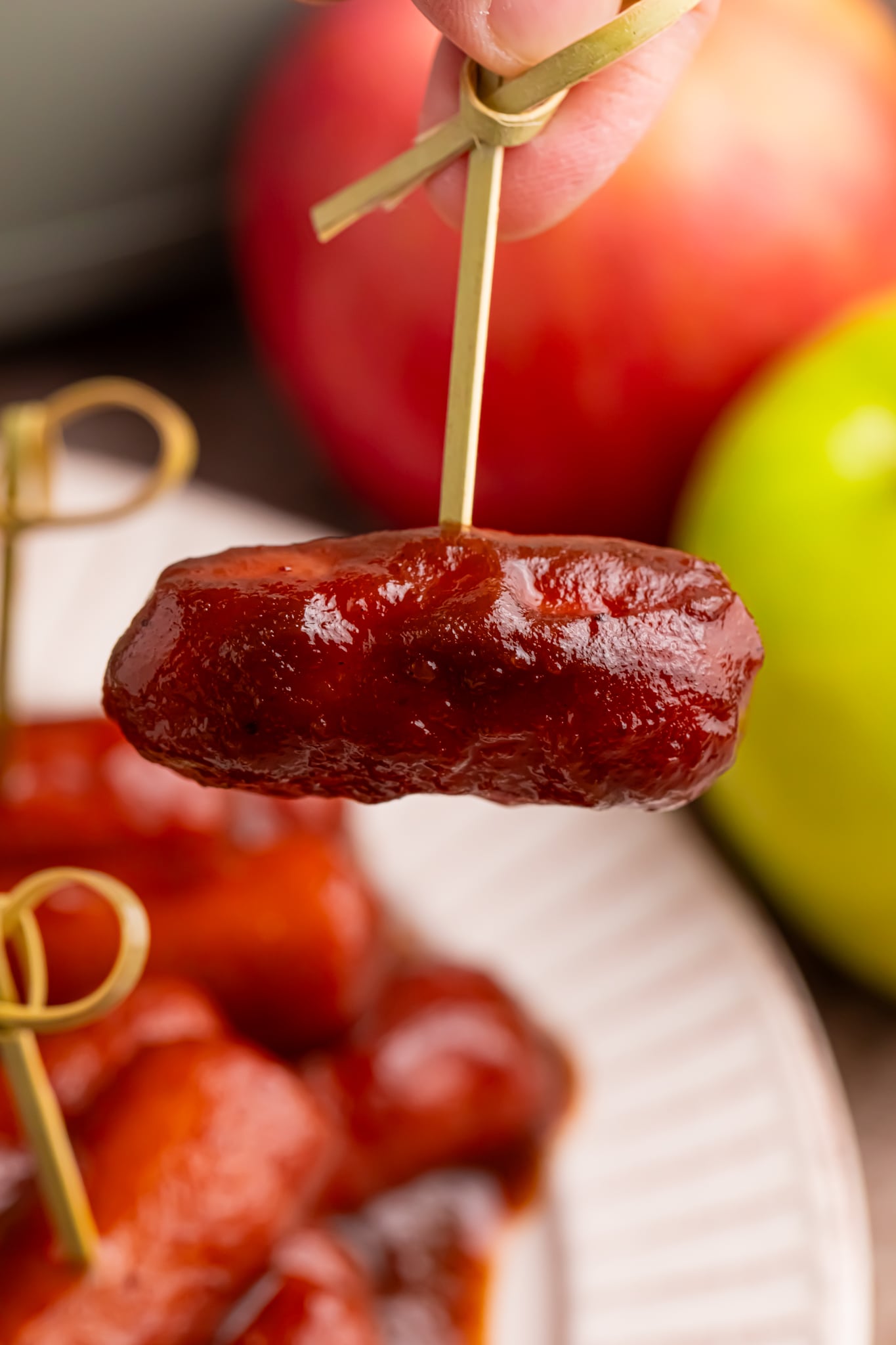 Apple Butter lil smokie on a toothpick being lifted up