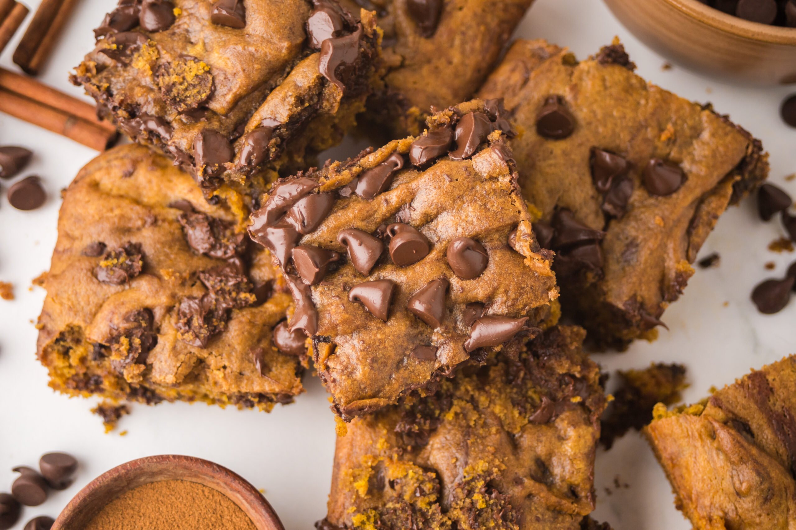 Overhead shot of the Brown Butter Pumpkin Chocolate Chip Bars stacked and sliced 