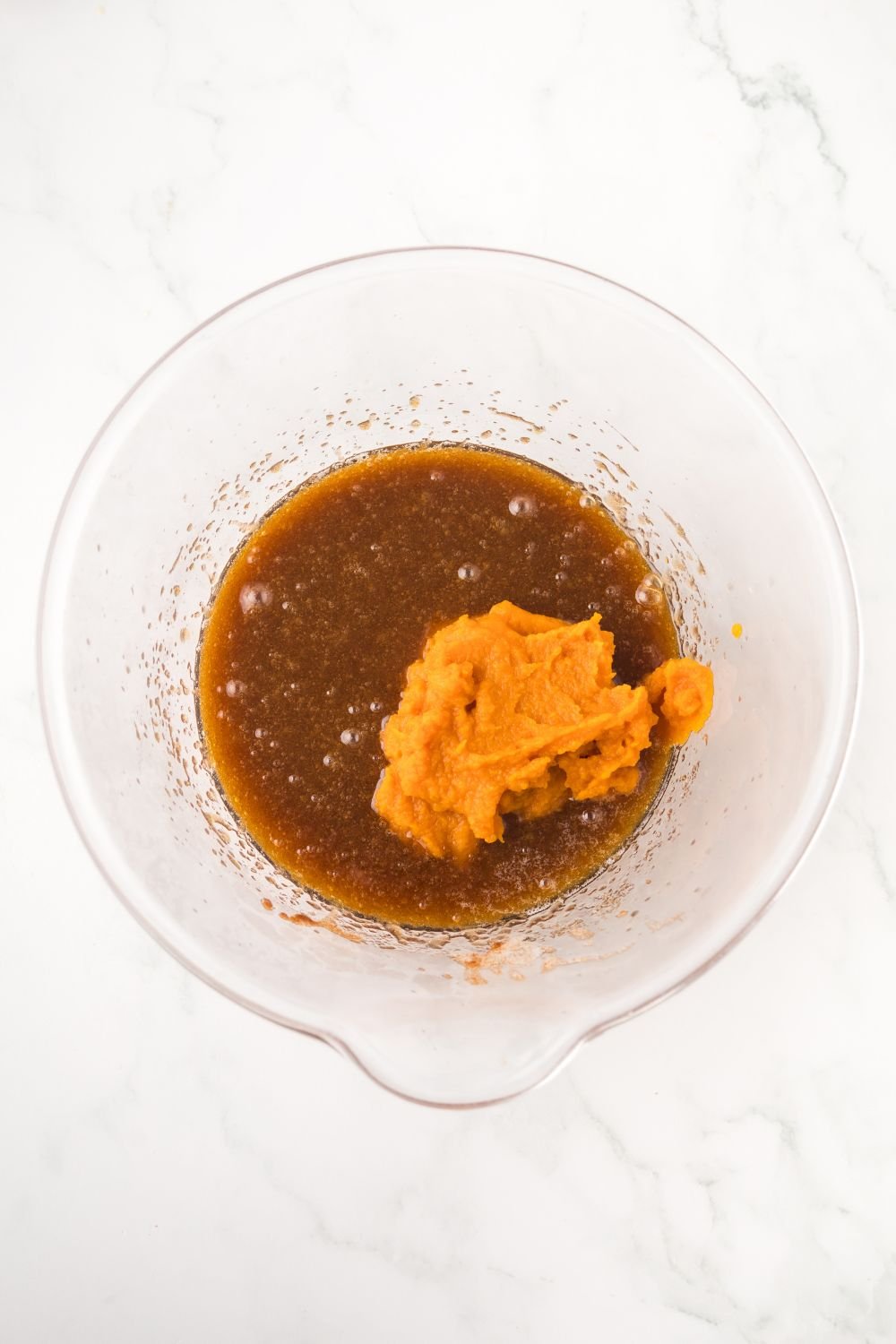 brown butter in a glass bowl with some pumpkin puree as well 