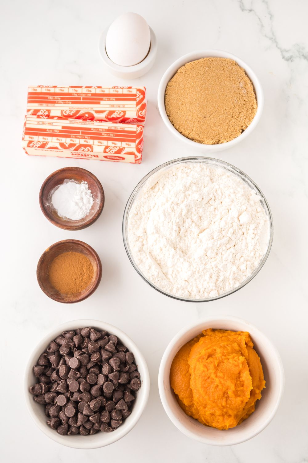 all the ingredients for Brown Butter Pumpkin Chocolate Chip Bars placed nicely on the table in single serve bowls 