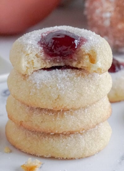 easy raspberry thumbprint cookies stacked on top of each other