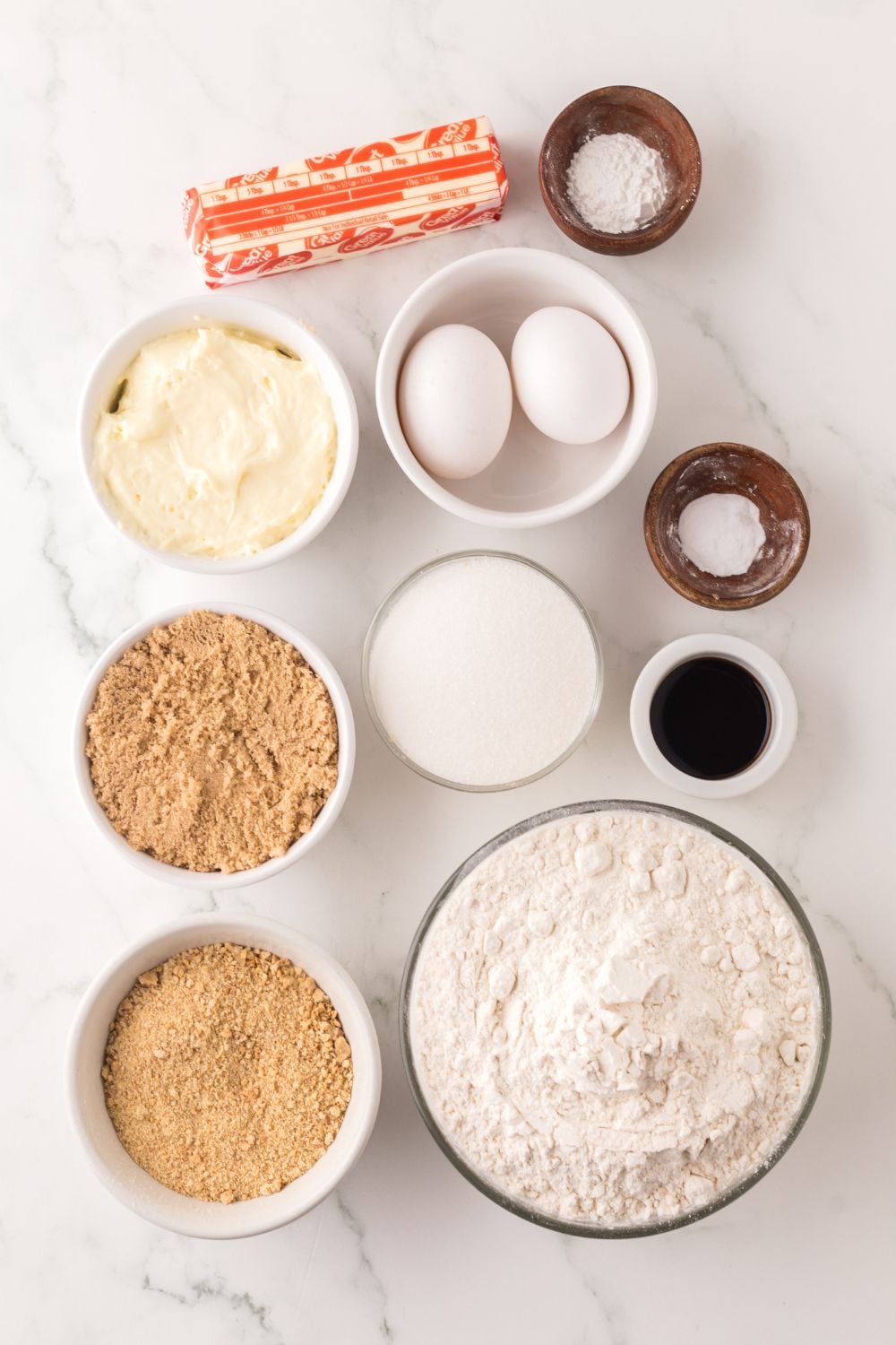 ingredients for Cheesecake stuffed cookies on table in single serve containers 