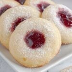 Raspberry Thumbprint Cookies on a white platter on the table
