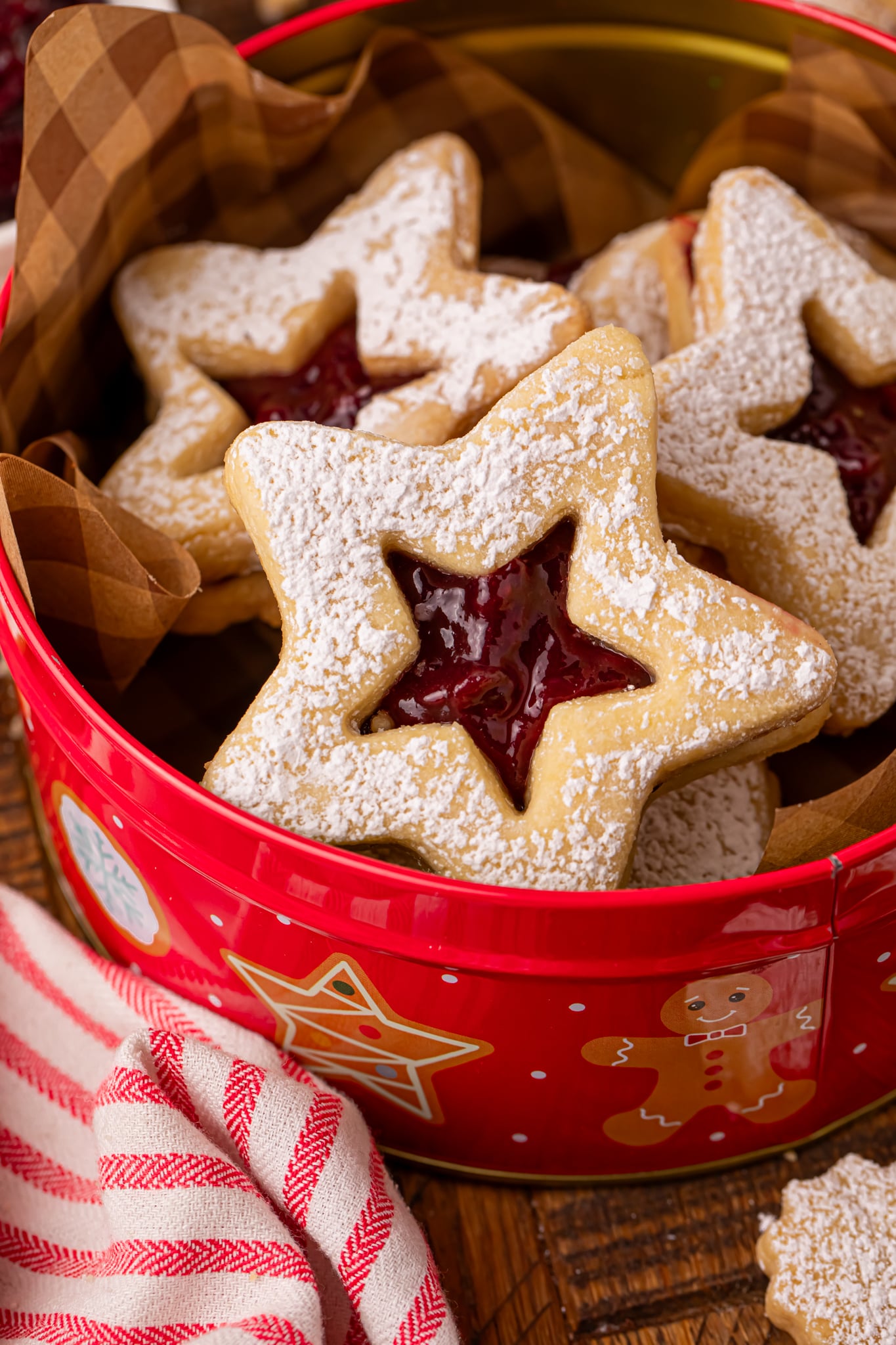 Easy Linzer Cookies with Jam Filling in a christmas cookie tin 