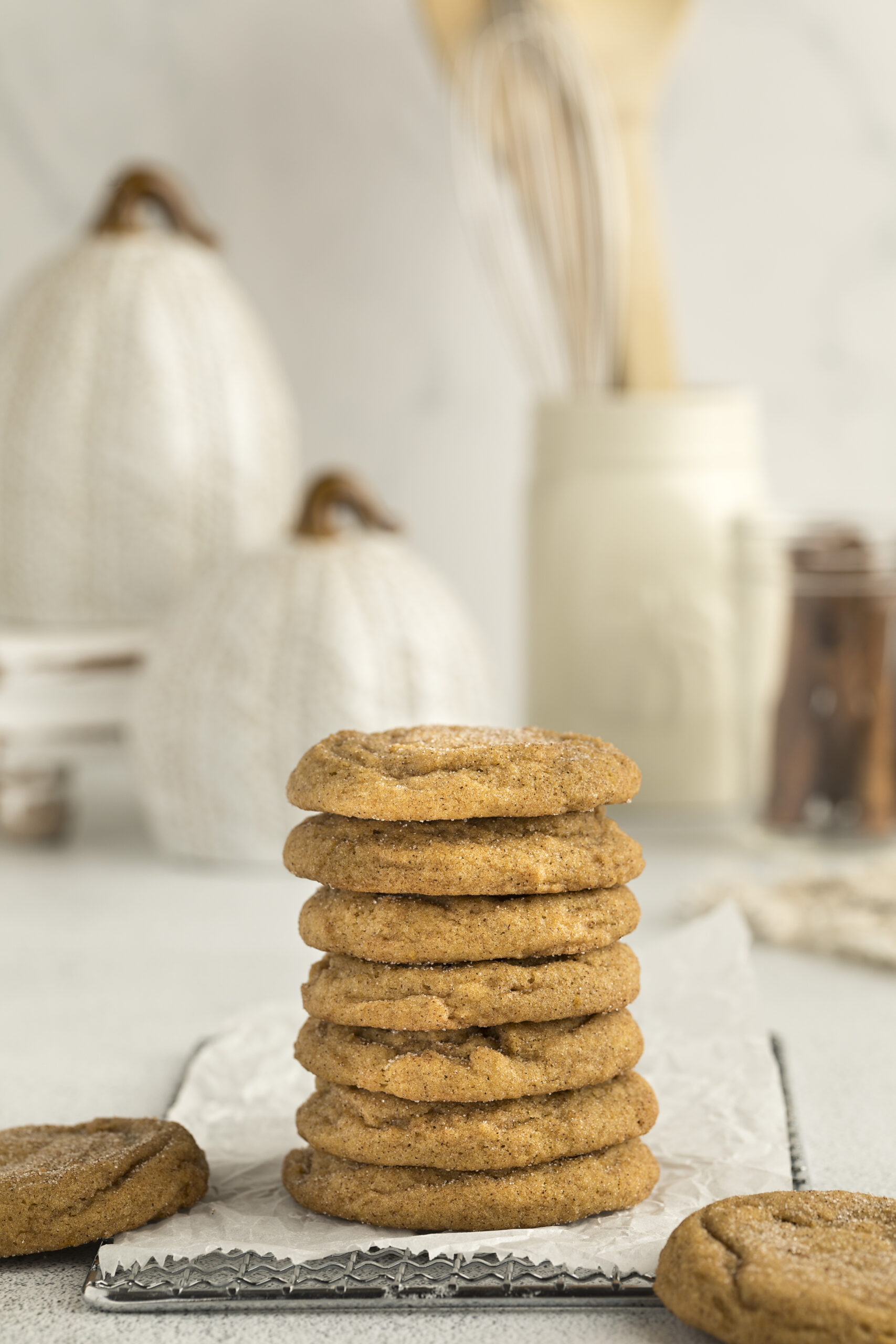 Pumpkin Snickerdoodle Cookies stacked on a white table 