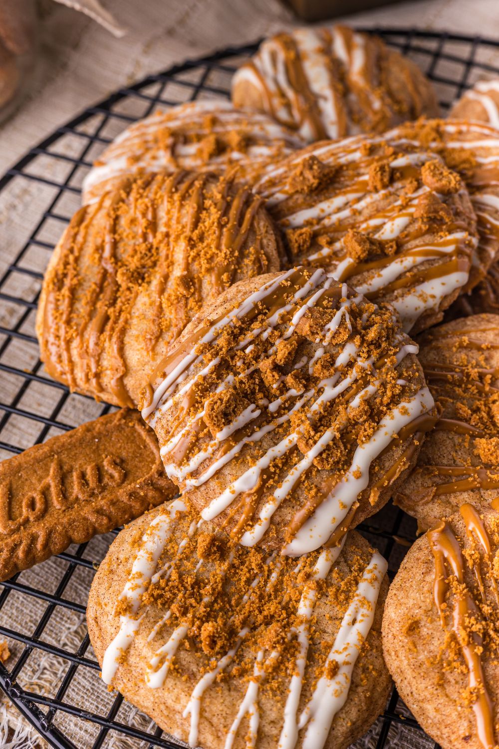 Biscoff Snickerdoodle Cookies stacked on top of one another on a wire cooling rack