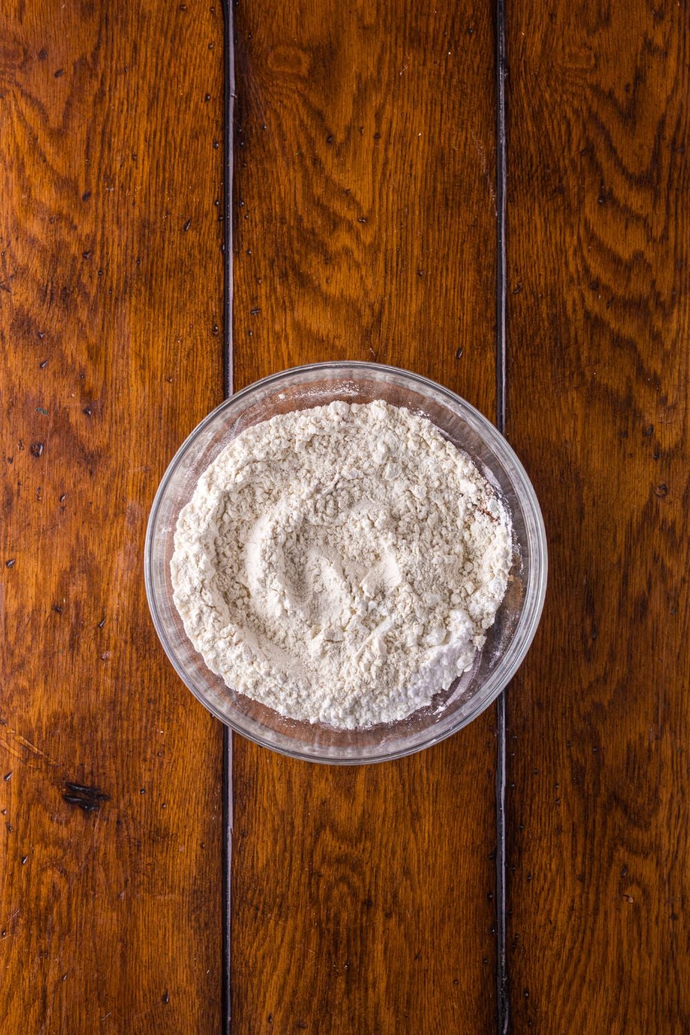 dry ingredients in a glass bowl on a wooden table
