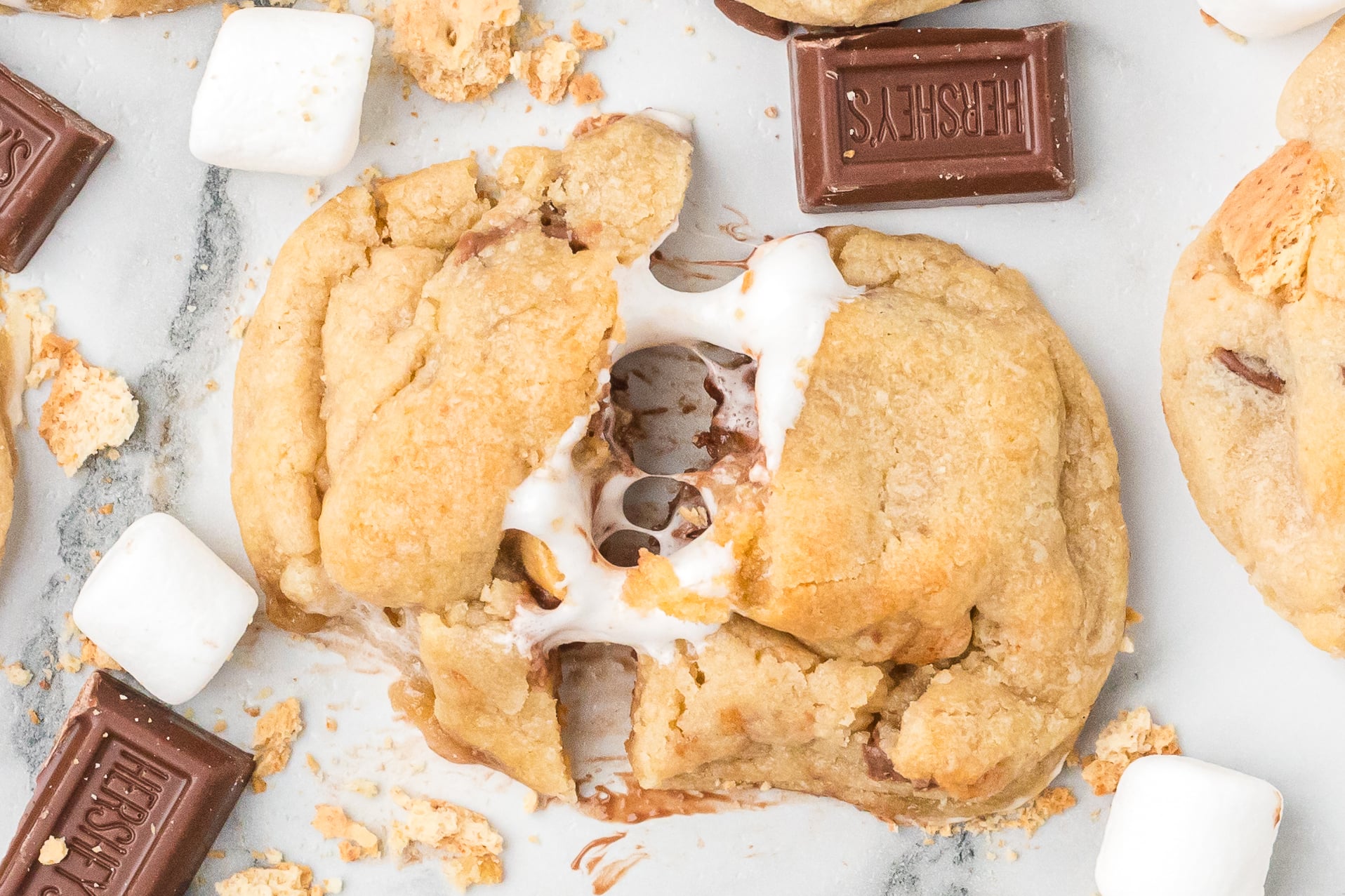 overhead shot of the S'mores Cookies with the center one being spit open showing the gooey marshmallow center 
