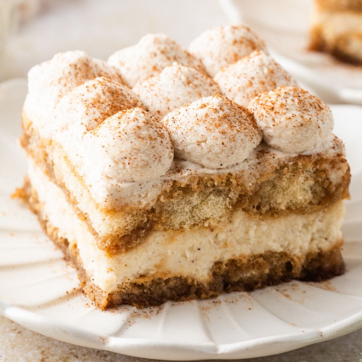 slice of Eggnog Tiramisu on a white plate on table 