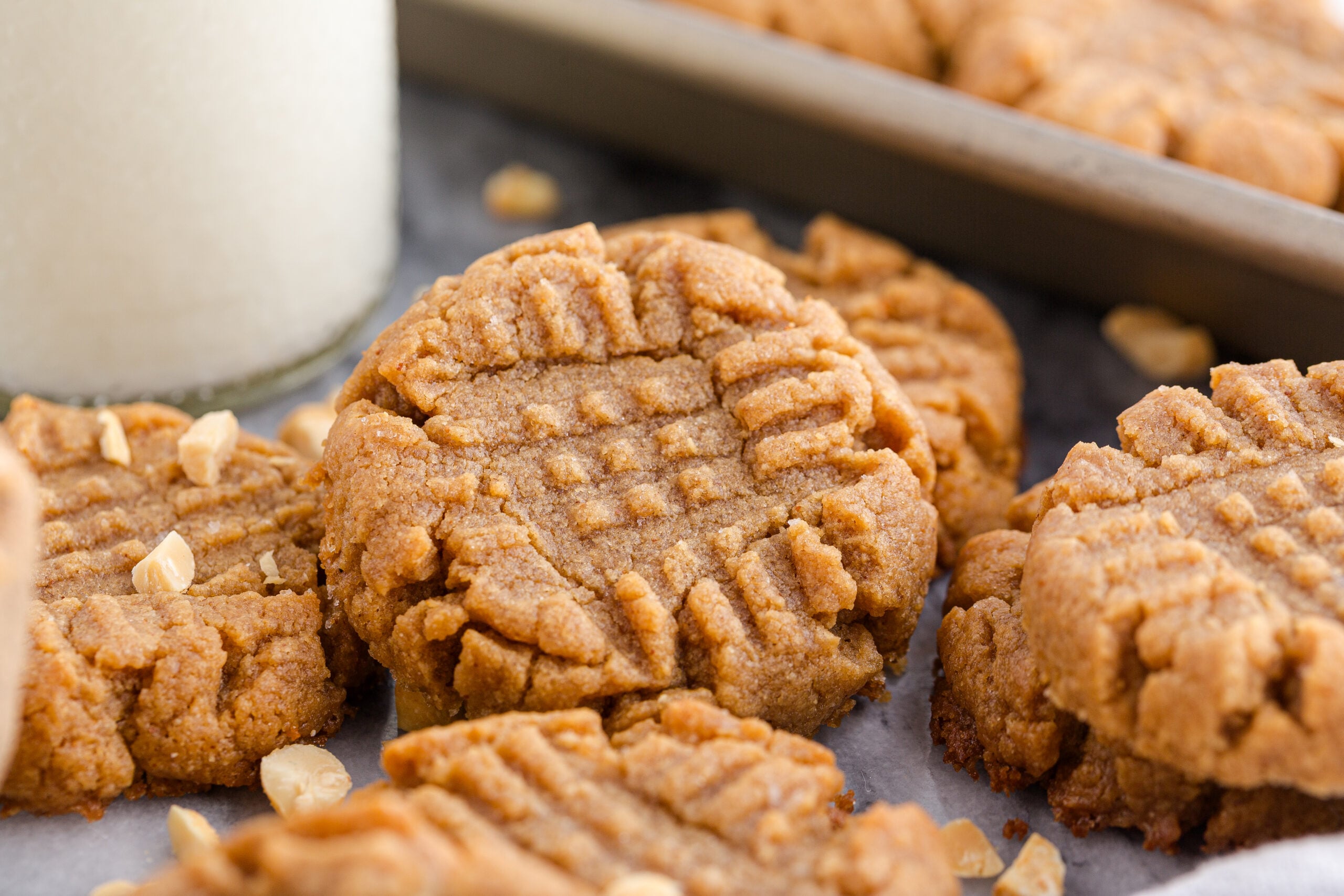 4 Ingredient Peanut Butter Cookies  with a cup of milk in the background