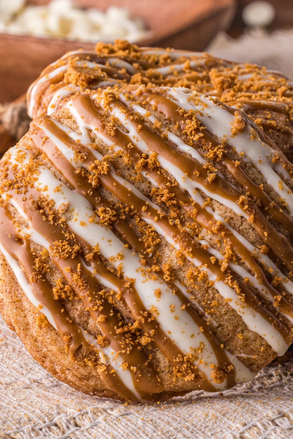 Biscoff Snickerdoodle Cookie tilted on the side that is topped with cookie crumbles and white chocolate