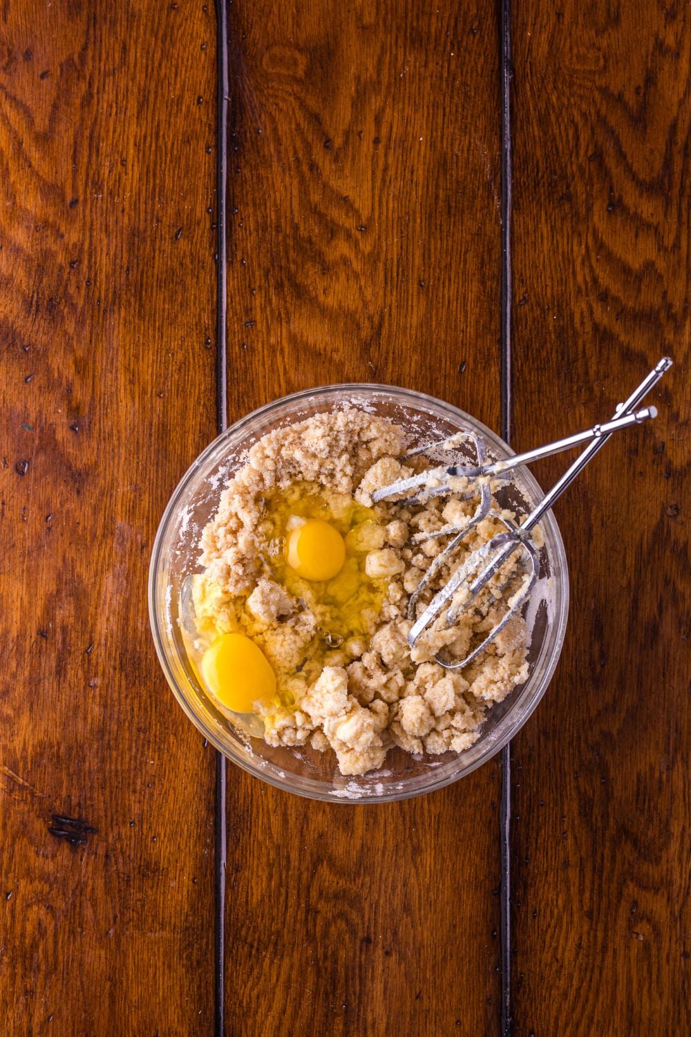 Biscoff Snickerdoodle Cookies dough in a glass bowl with mixers to side 