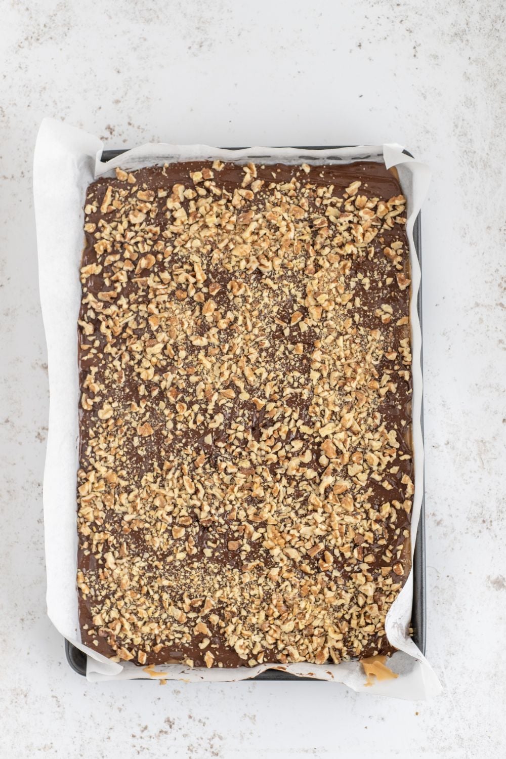English Toffee in a baking sheet on table 