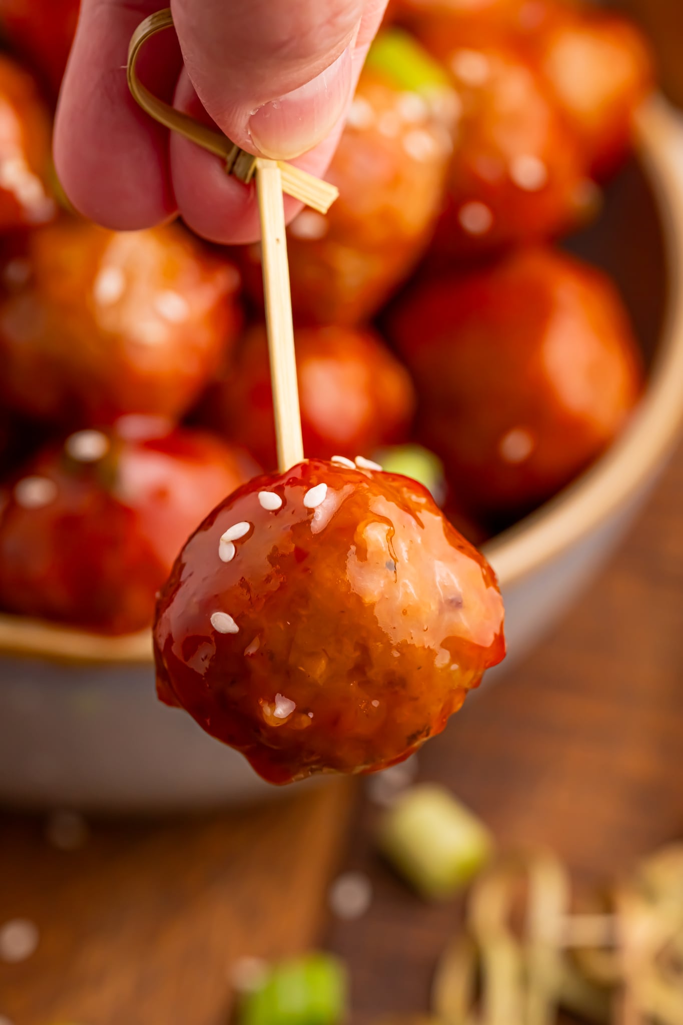 Crockpot Sweet Chili Meatball on a toothpick being held up