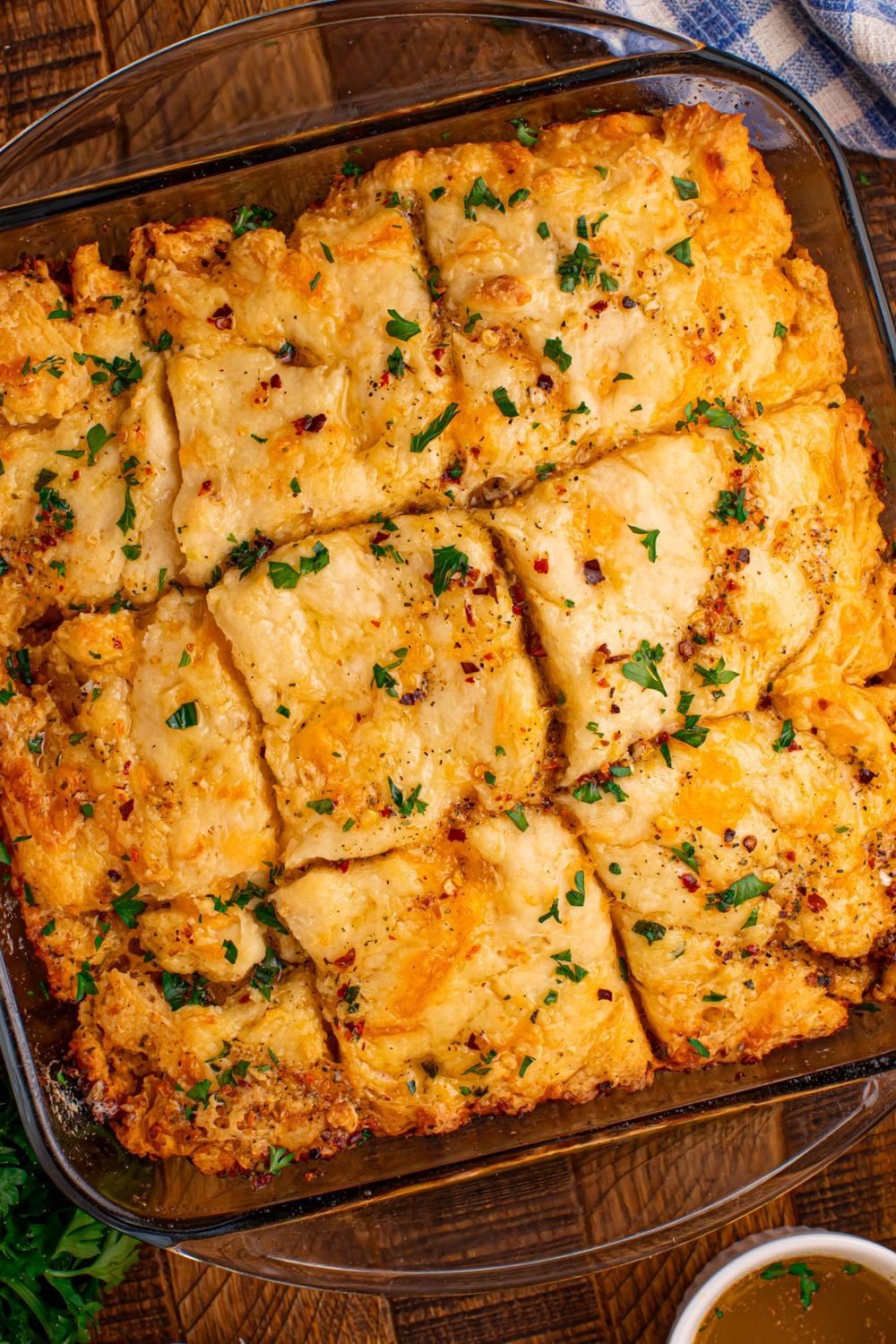 looking down on the table in a glass pan full of cut Cowboy Butter Swim Biscuits
