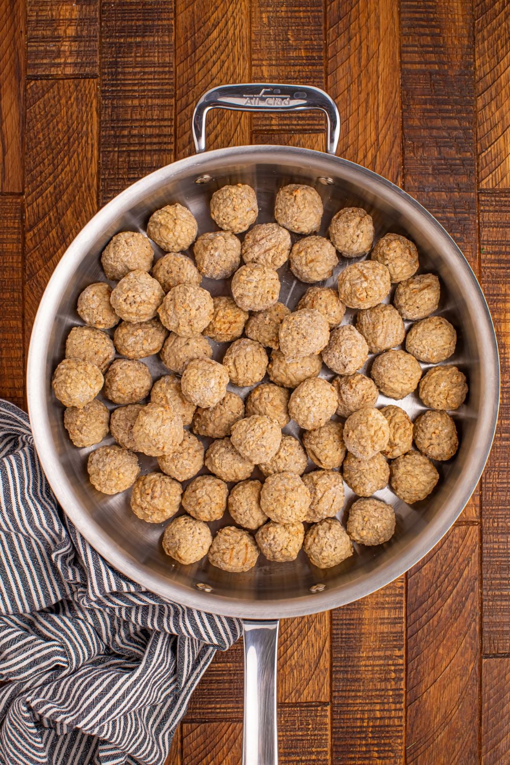 frozen meatballs in a skillet on the table
