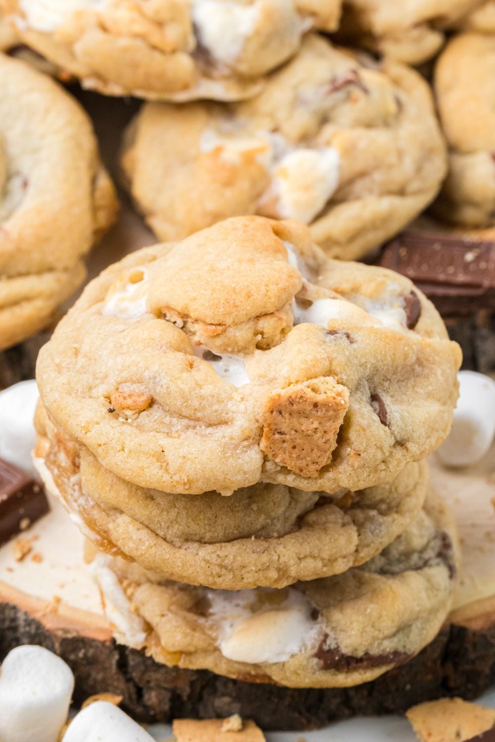 stack of S'mores Cookies and then more cookies around the table with mini marshmallows 