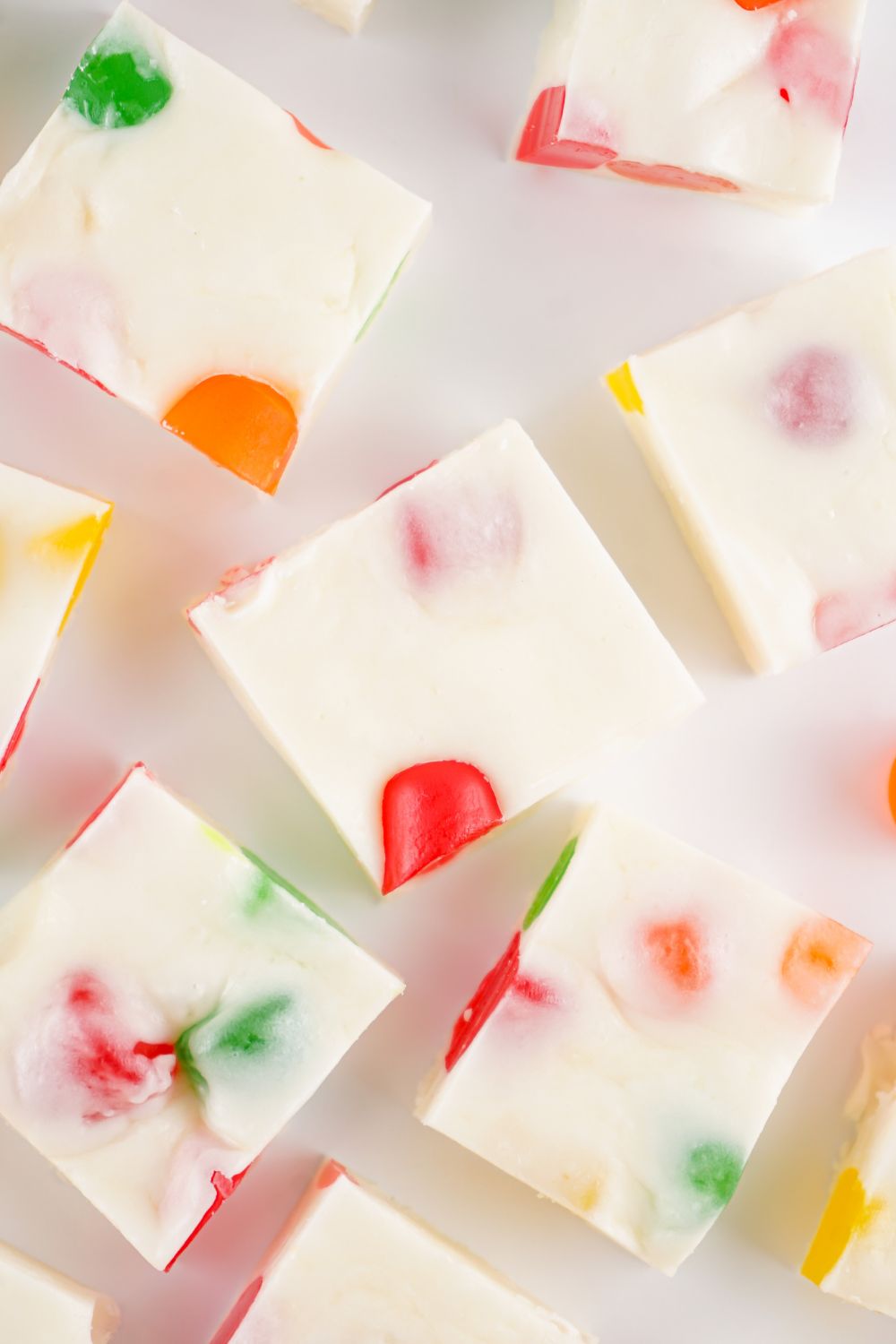 slices of Christmas Gumdrop Nougat Candy spread around a white table 
