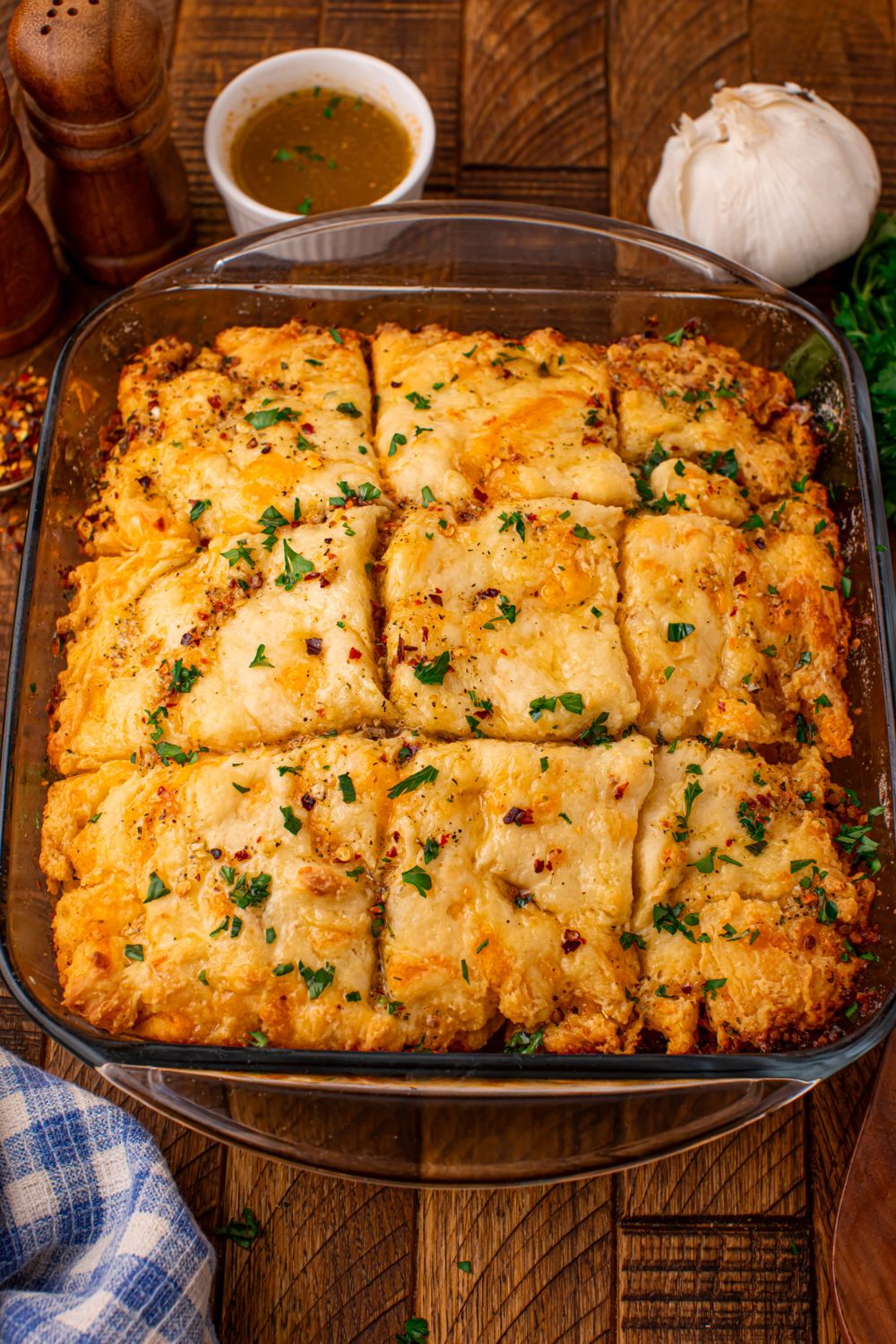 looking at the table with a pan of cowboy butter biscuits and then a garlic and small bowl of seasonings