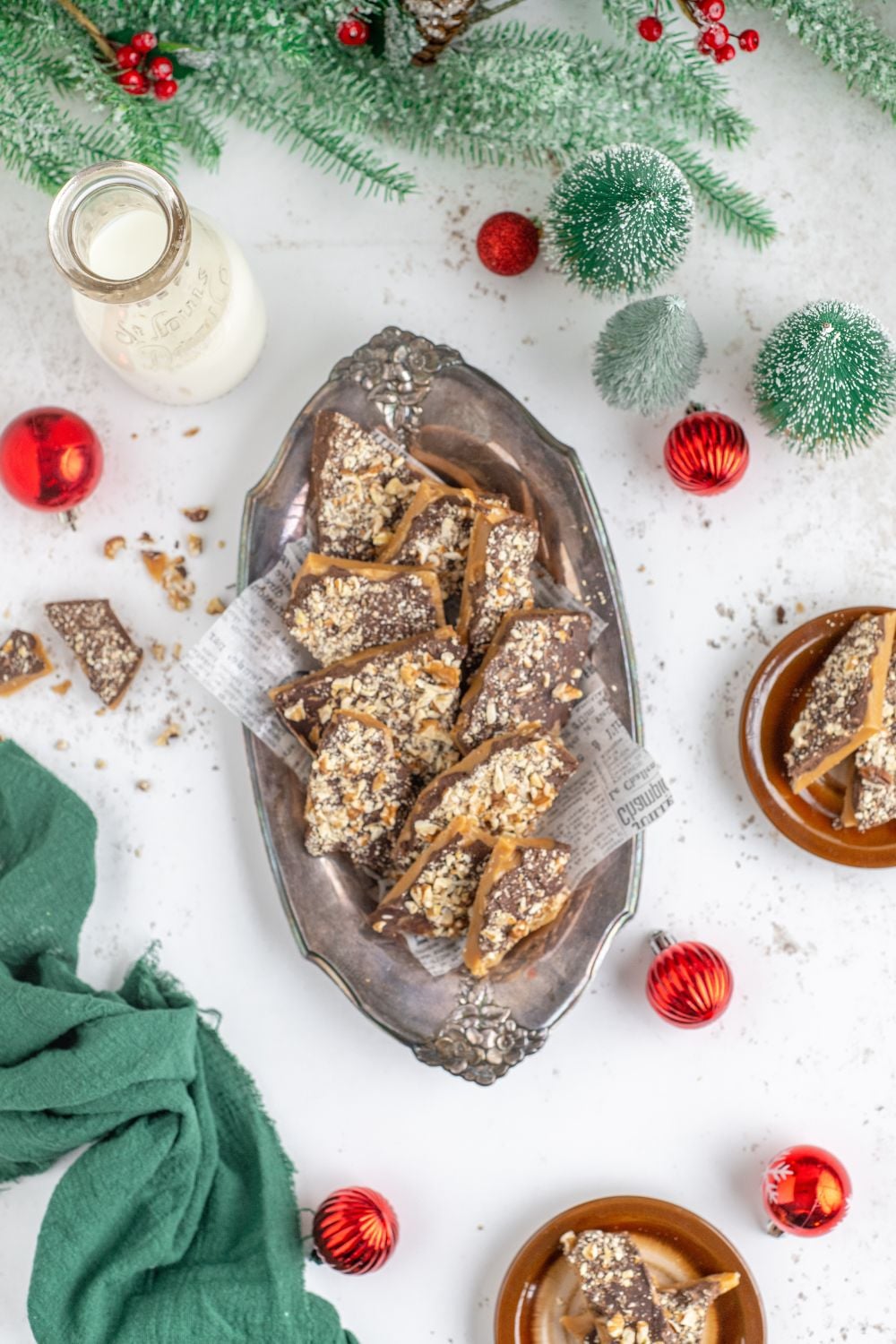 Christmas decor on a white table with a large platter full of English Toffee