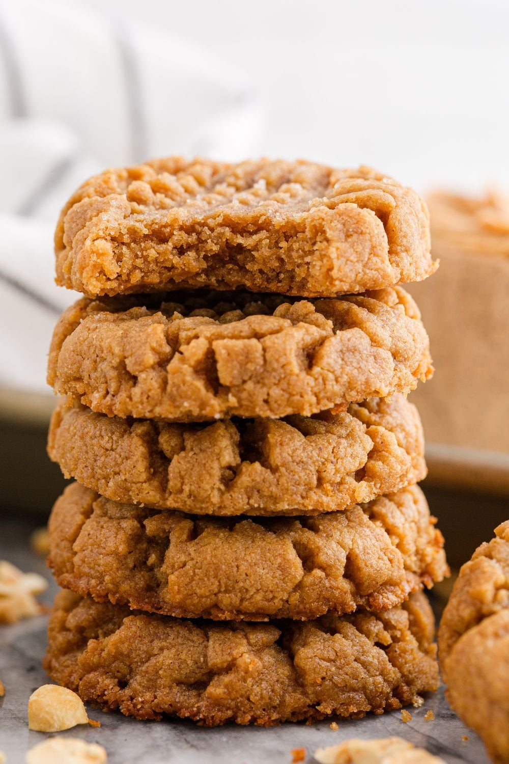 stack of peanut butter cookies with a bite taken out of the top of the cookie