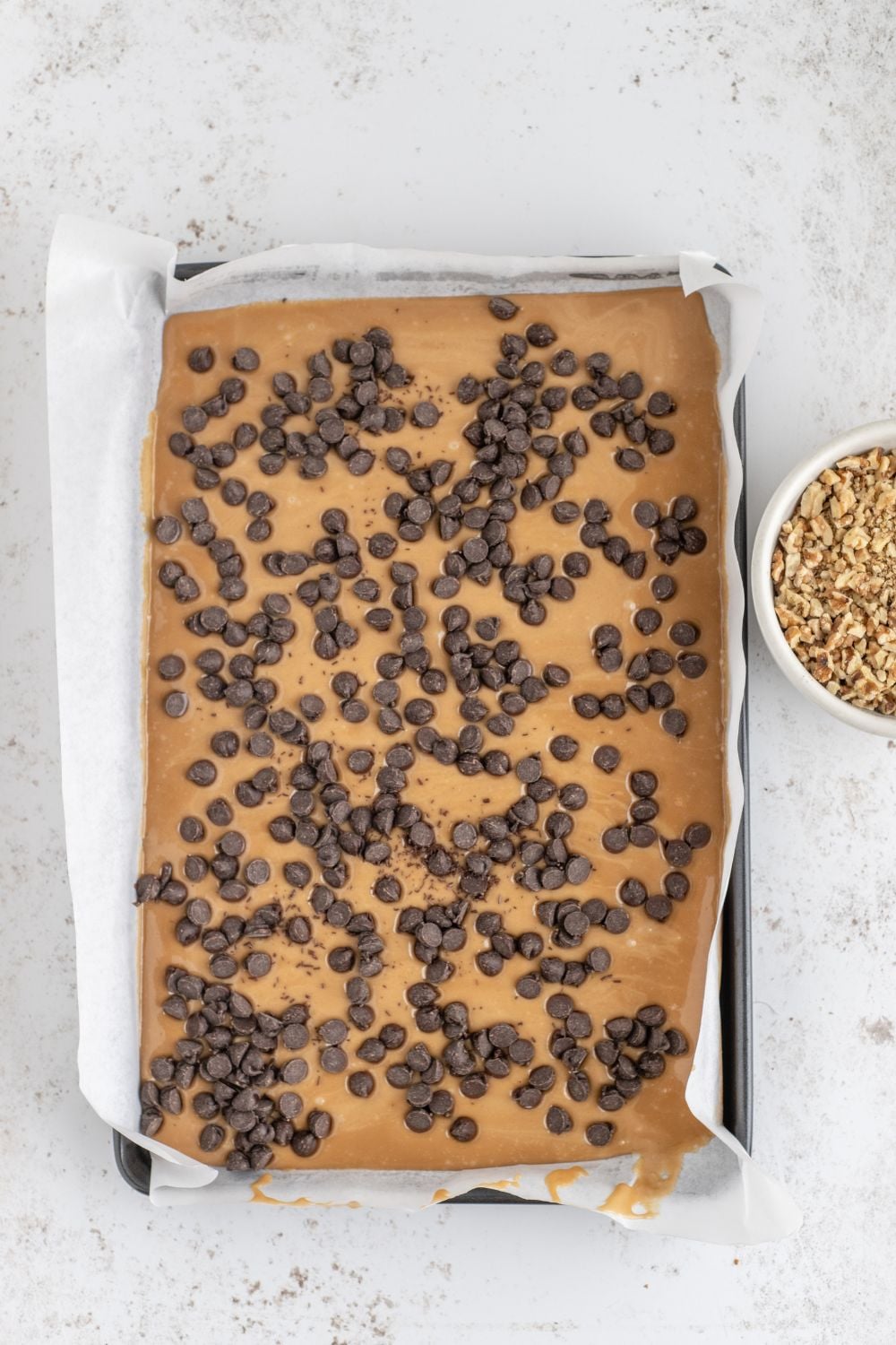 chocolate chips topped on softened toffee 