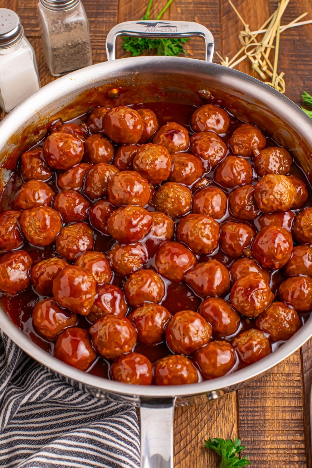 skillet full of Peach BBQ Meatballs on a wooden table