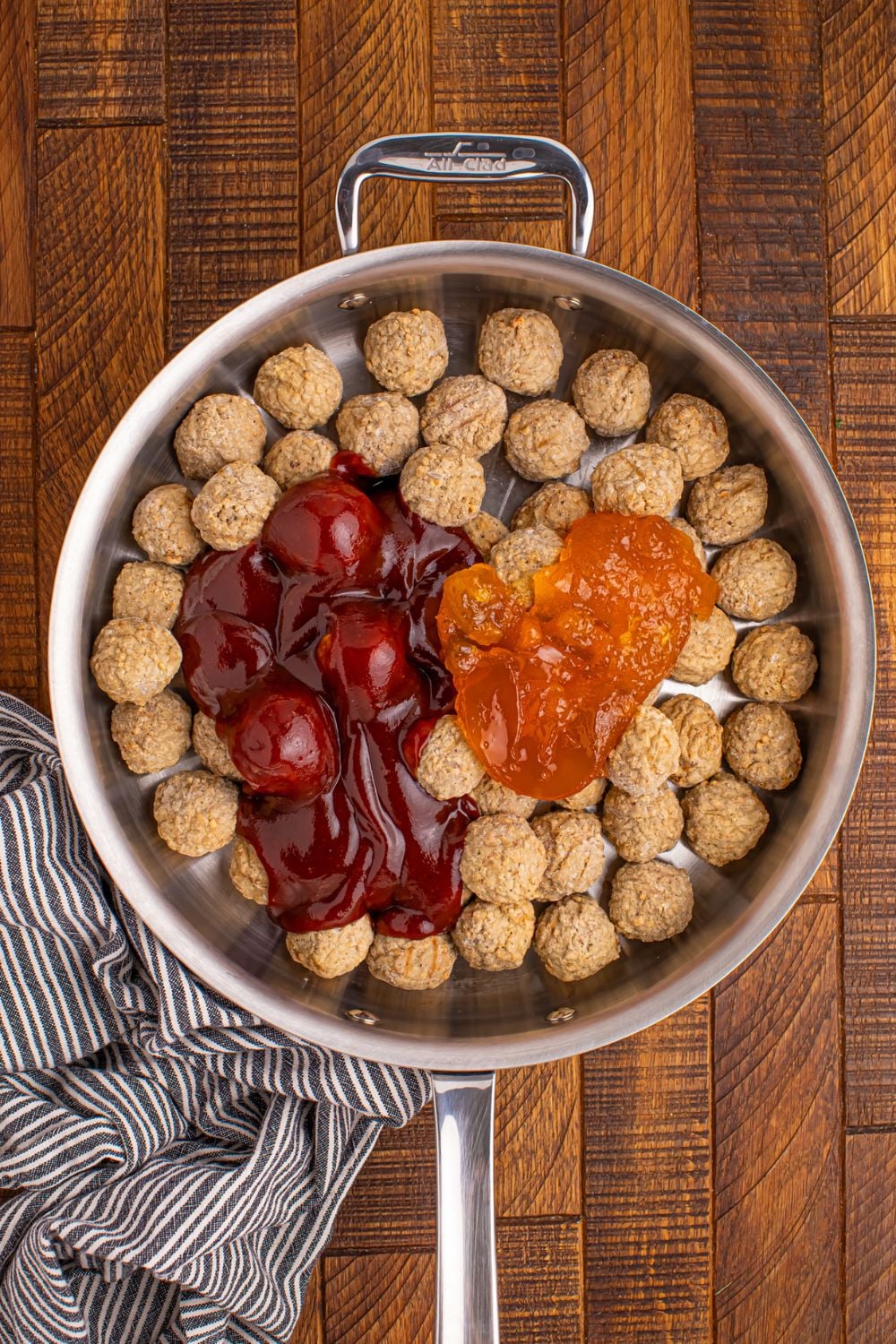 frozen meatballs in a skillet with sauce in it waiting to be cooked