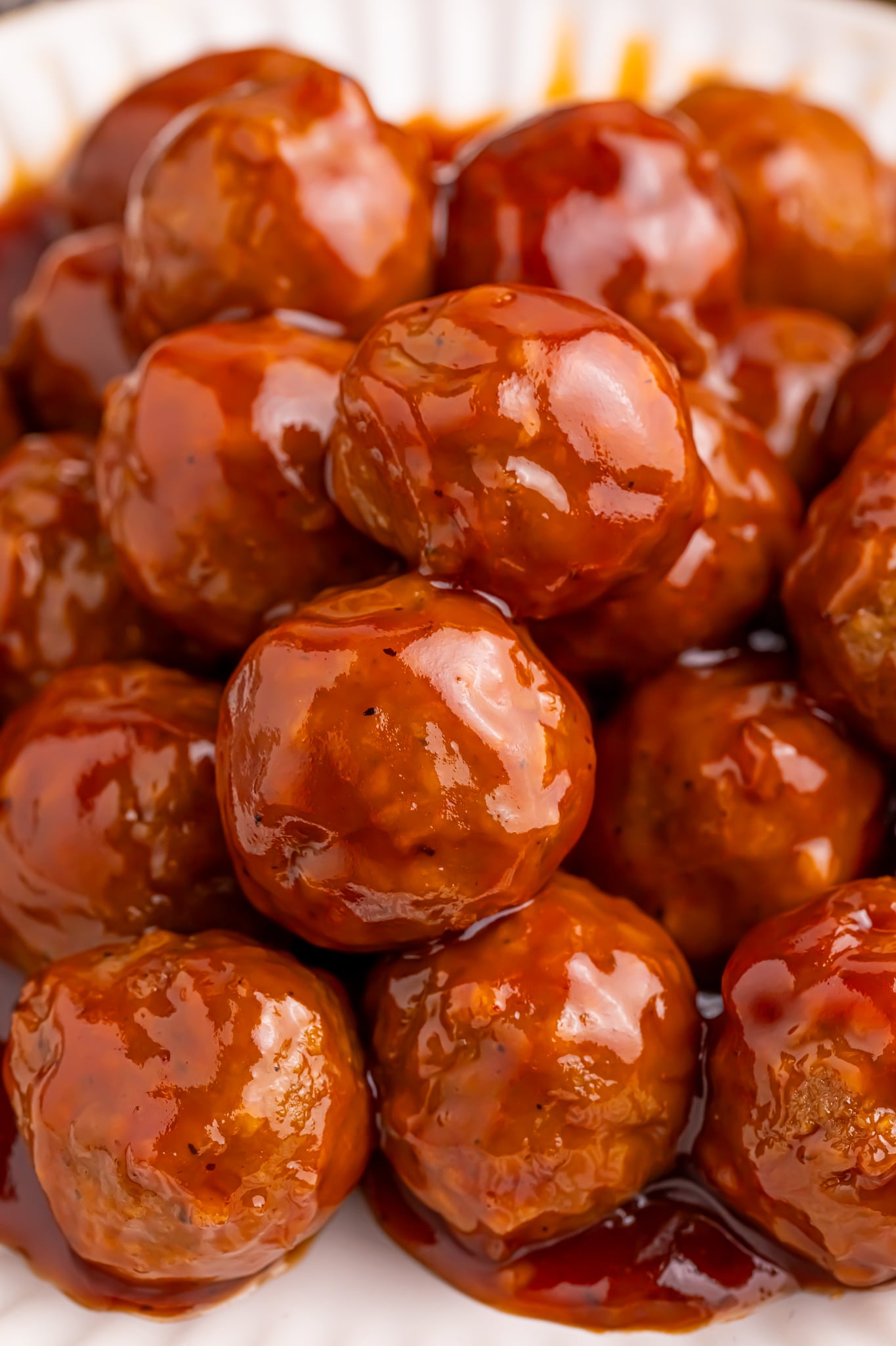 Up close shot of a white Plate of Peach BBQ Meatballs