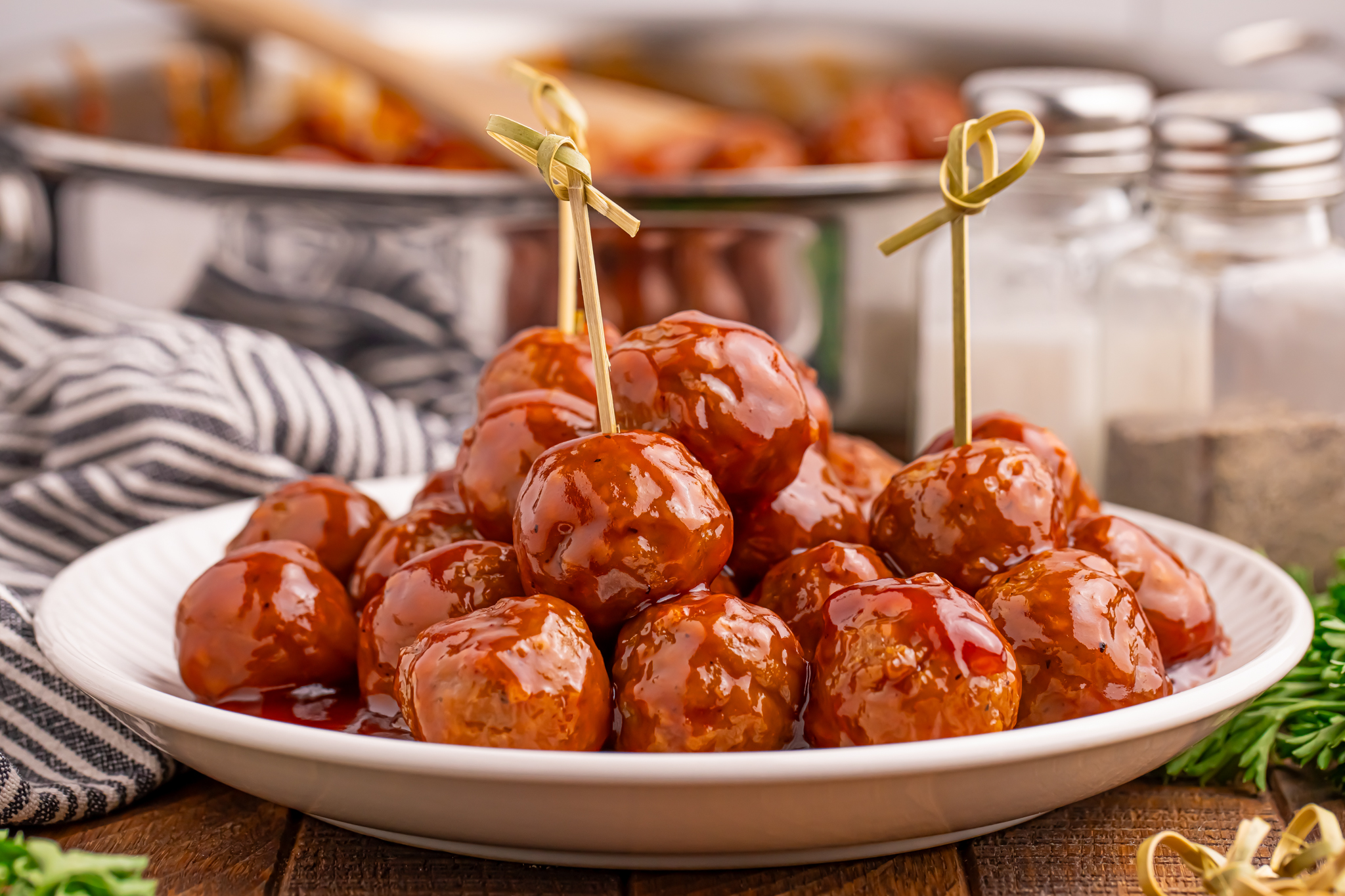 Plate of Peach BBQ Meatballs with toothpicks in some 