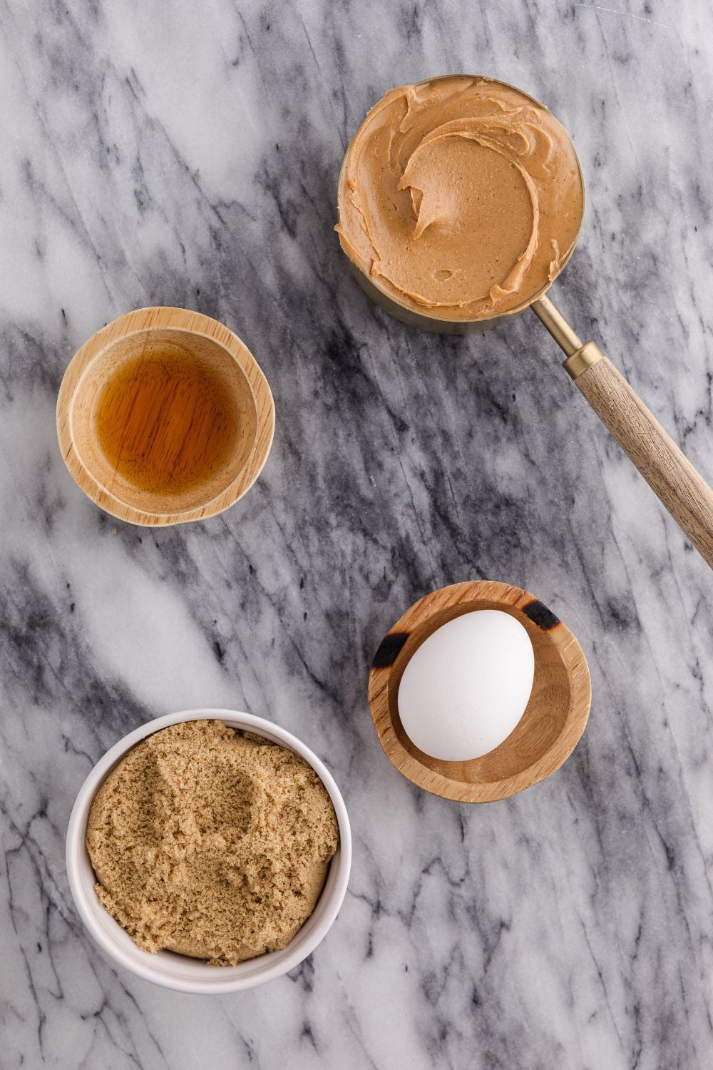 all the ingredients for making 4 Ingredient Peanut Butter Cookies on a marble counter 
