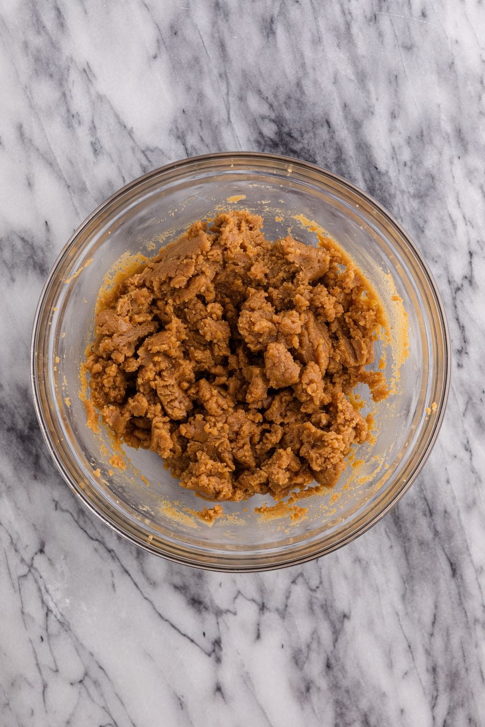 a glass bowl of peanut butter mixture 