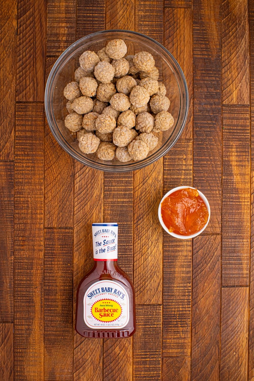 Peach BBQ Meatballs ingredients on table in single serve bowls, and a bottle of bbq sauce