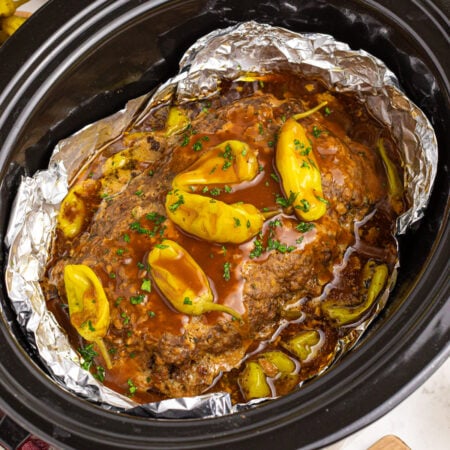 Crockpot Mississippi Meatloaf in a black slow cooker lined with foil