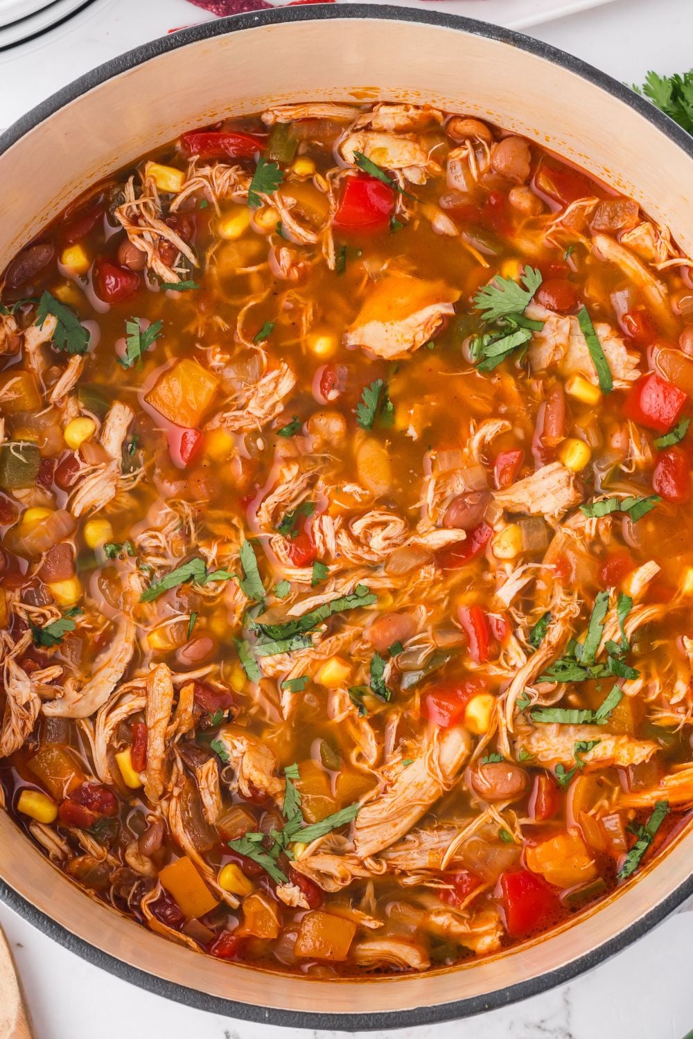 Southwestern Chicken Soup in a red and white pot on a table 