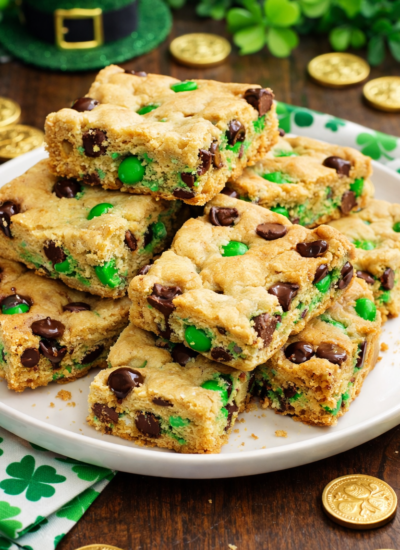 Saint Patrick's Day Chocolate Chip Cookie Bars on a white plate with st paddys day decor