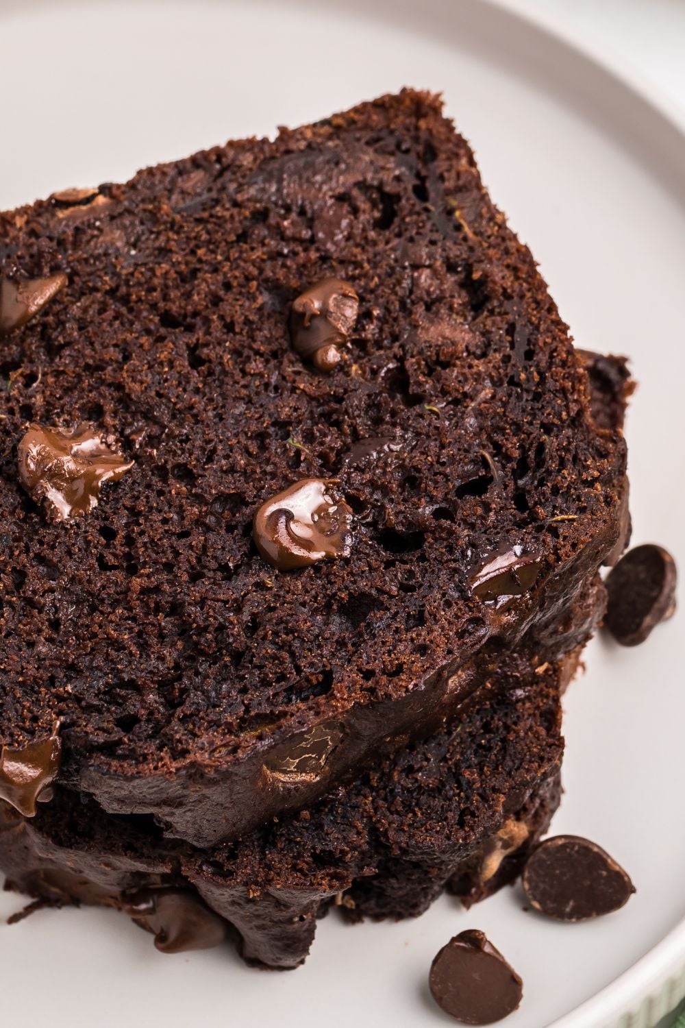 a couple of slices of chocolate zucchini bread on a white plate